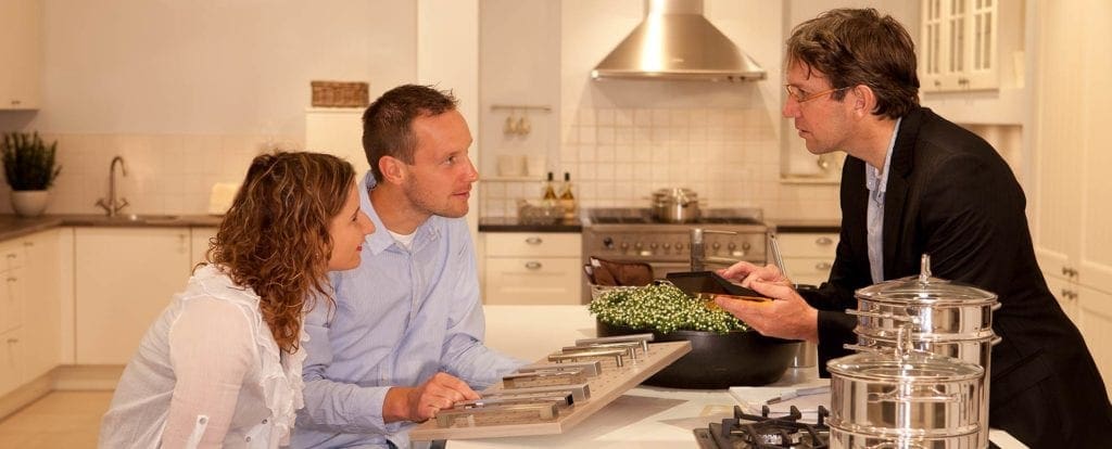 designer-guy Couple discussing design plans with home builder