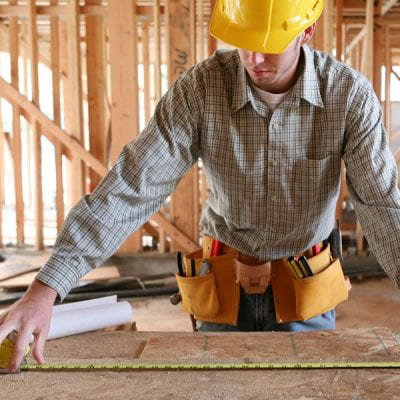 contractor working in a framed house
