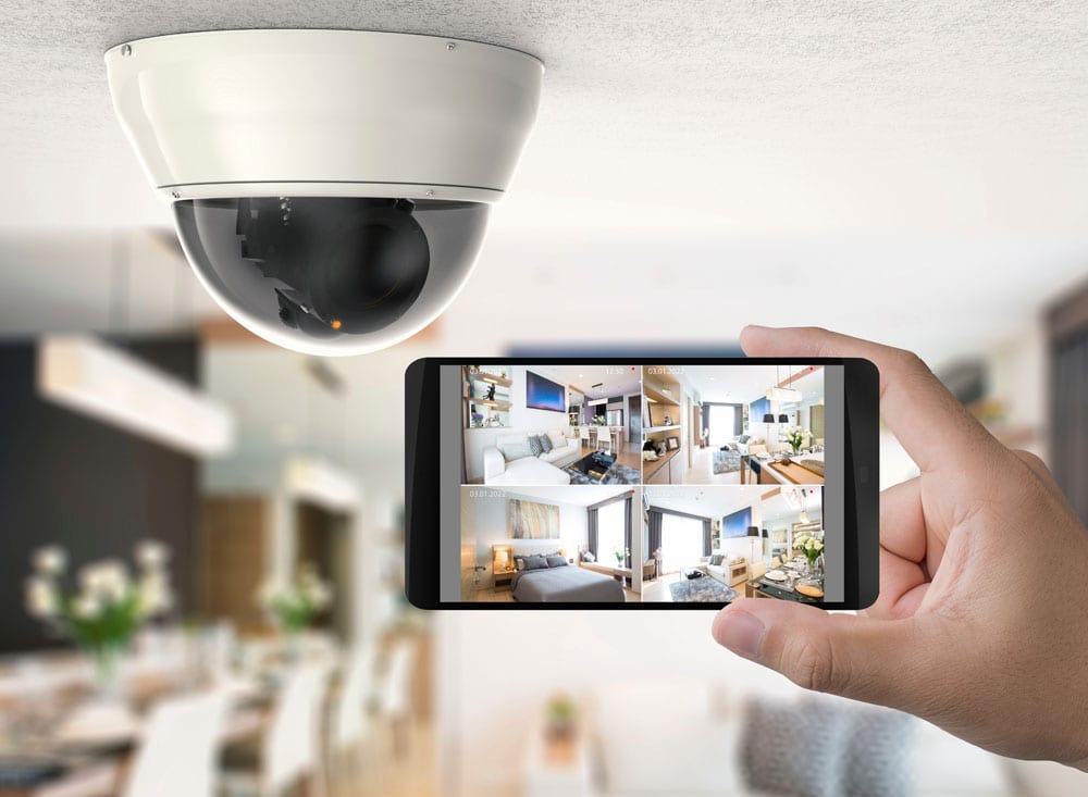 surveillance systems surveillance system featuring a cctv camera and a mobile phone showing the surveillance app