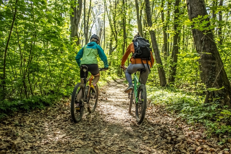 Couple biking in woods